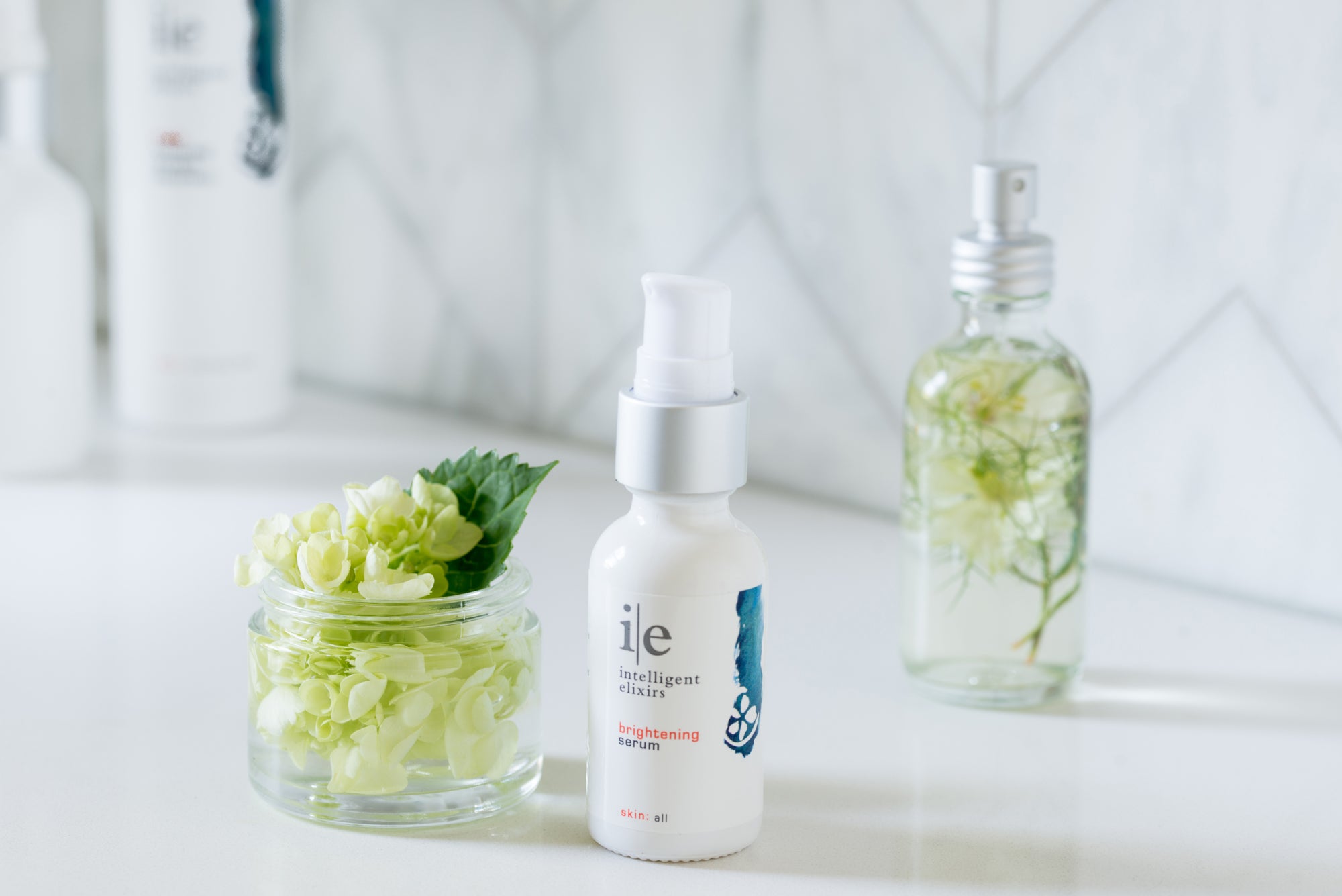 Brightening Facial Serum for dull skin or pigmentation next to a flower in a jar