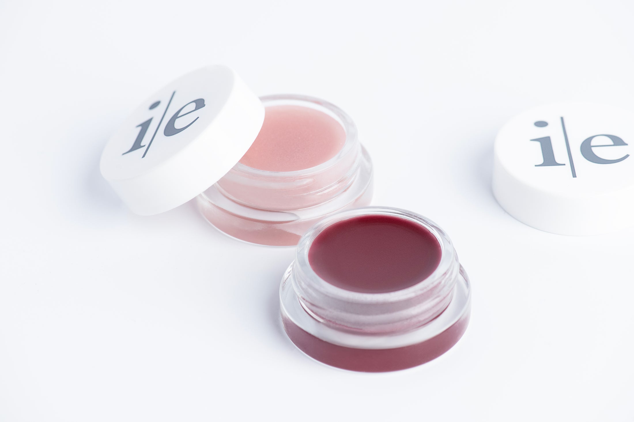 Two Lip Elixir lips balms in color sheer and plum