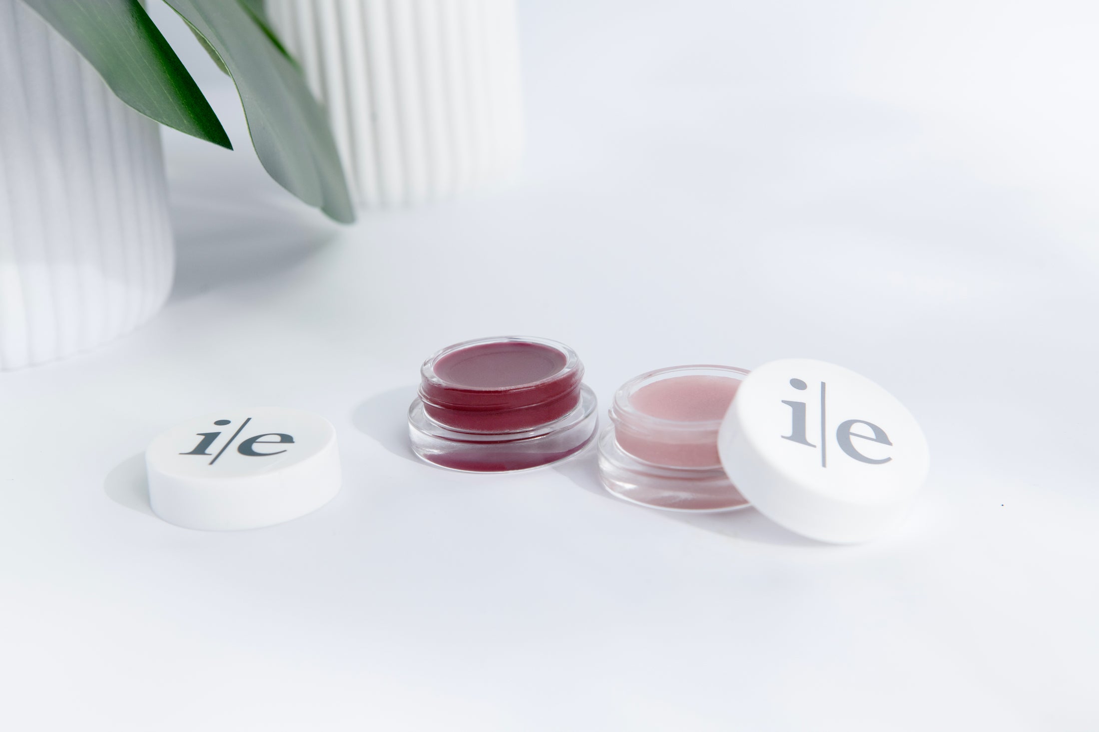 Two Lip Elixir lips balms in color sheer and plum