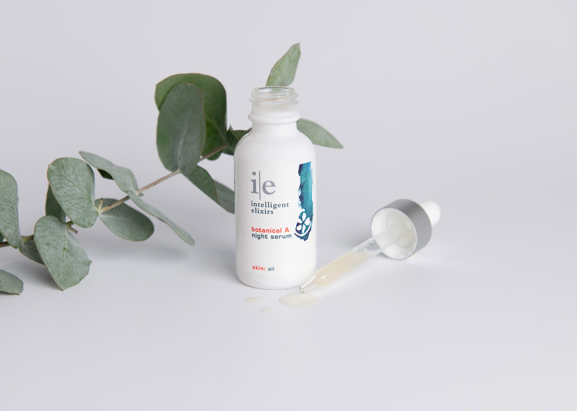 Botanical A Night Skincare Serum next to a sprig of Eucalyptus
