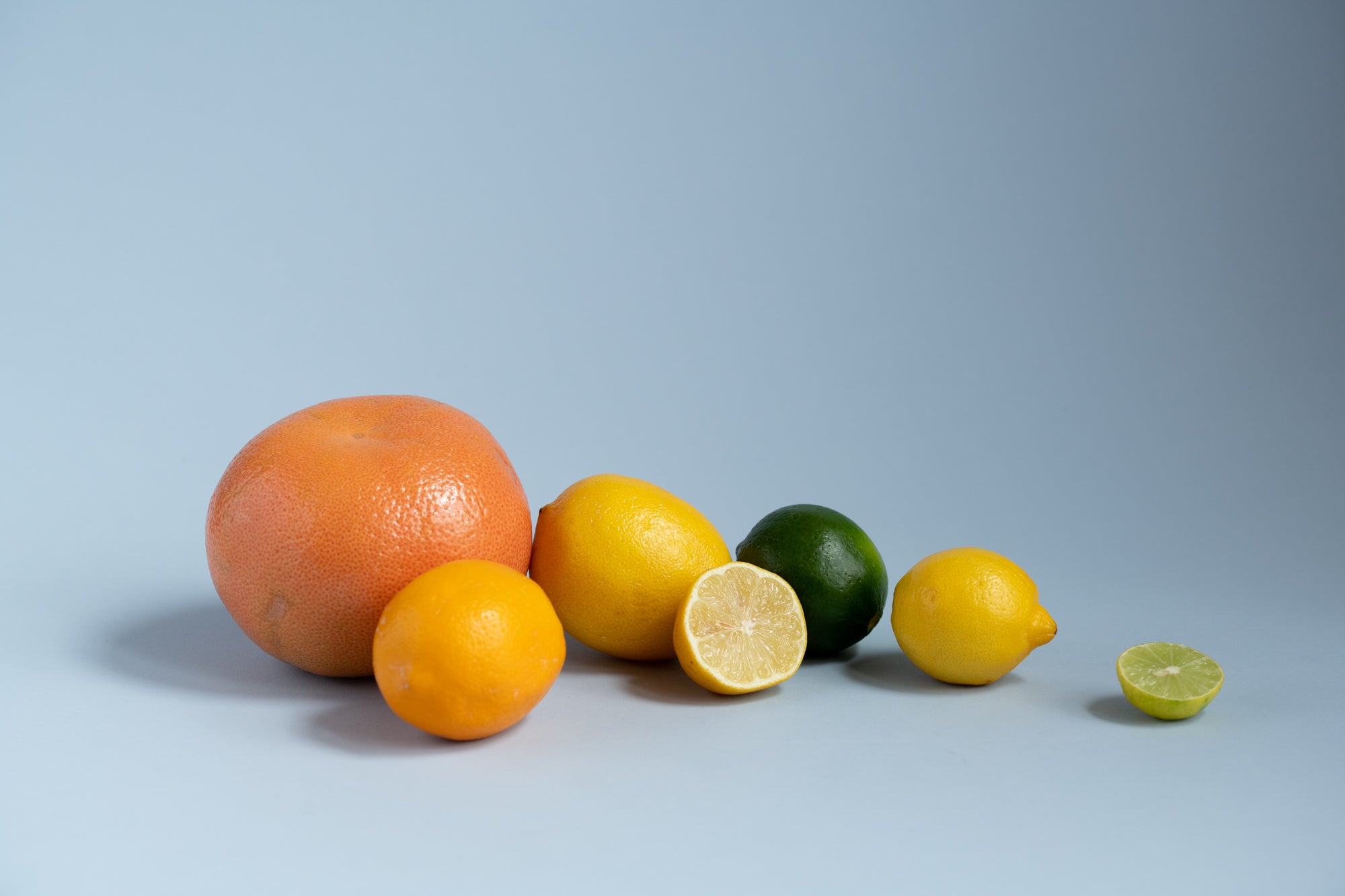 Various citrus fruits on a blue background