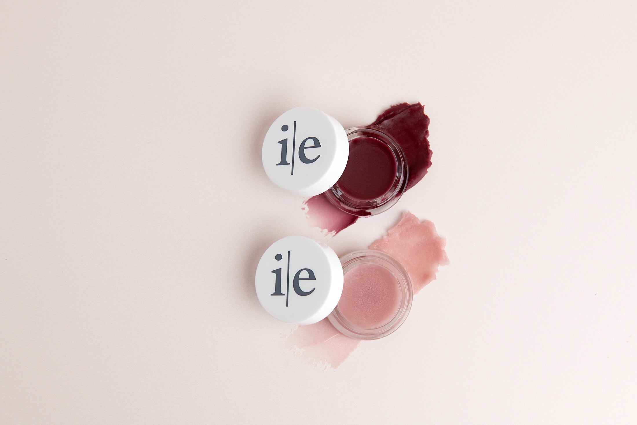 Two Lip Elixir lips balms in color sheer and plum