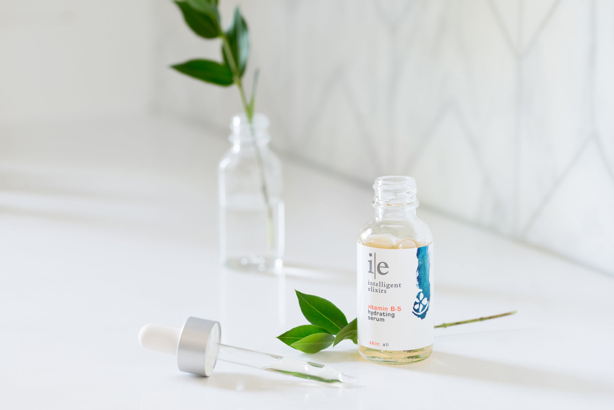 Vitamin B-5 Skincare Serum sitting on a counter with a plant