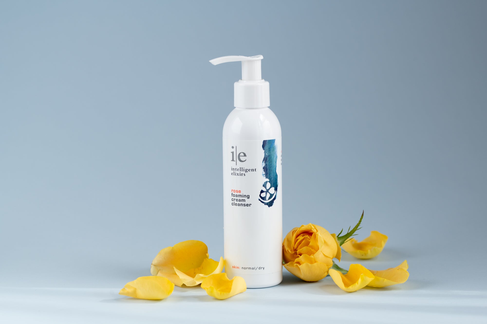 Rose Cleansing Cream Facial Cleanser next to yellow flowers